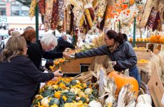 Ottawa, Canada - October 11, 2014: Shoppers at Byward Market in Ottawa during the day. Various fruit and vegetables can be seen.